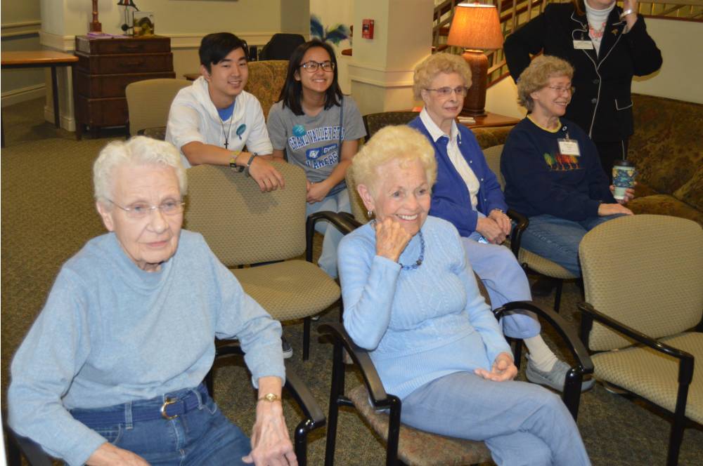 Seniors enjoy watching people play Wii Bowling.